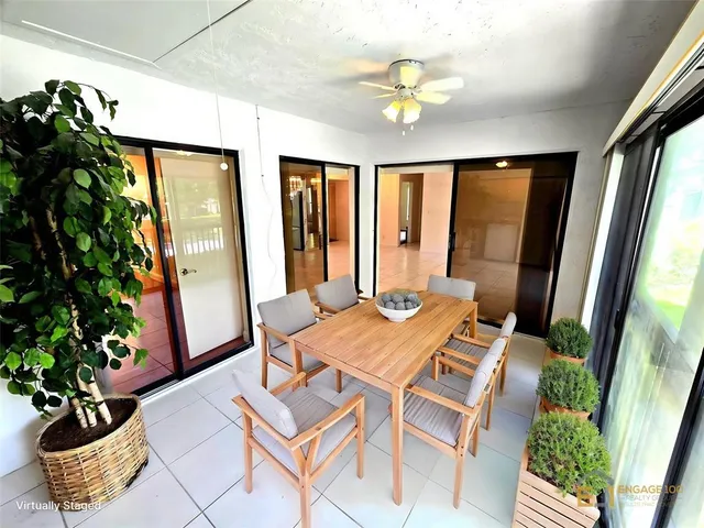 a view of a dining room with a table and chairs