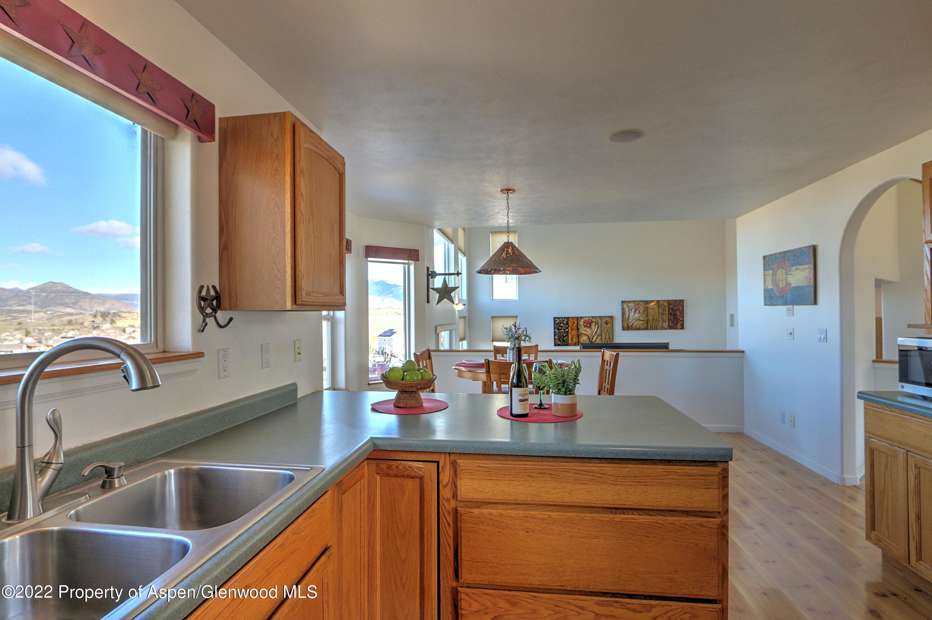 1220 Sage Court Rifle, CO 81650 - Photo 19 of 41 a kitchen with kitchen island granite countertop a sink and a counter top space