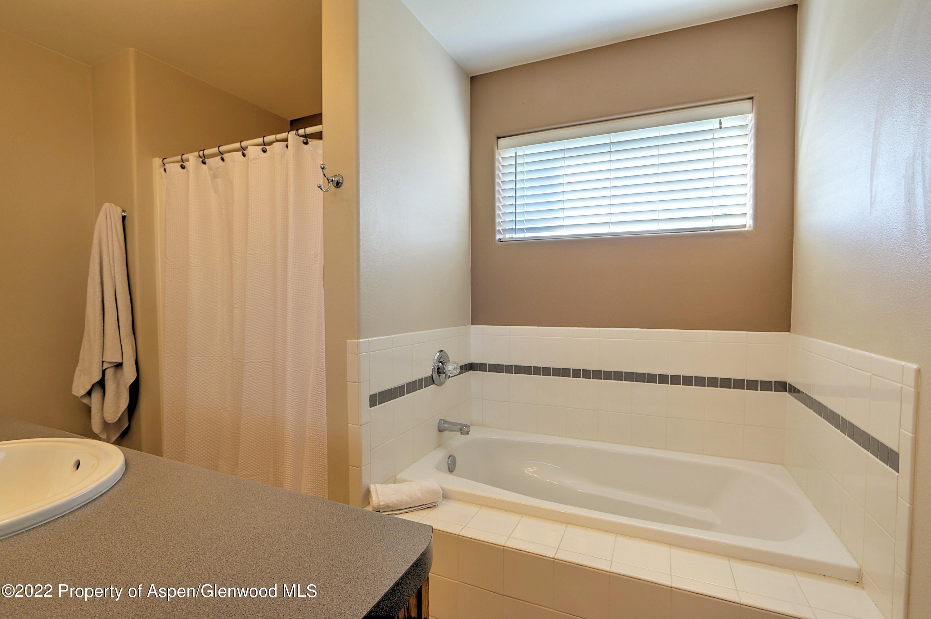 1220 Sage Court Rifle, CO 81650 - Photo 25 of 41 a bathroom with a tub and a sink