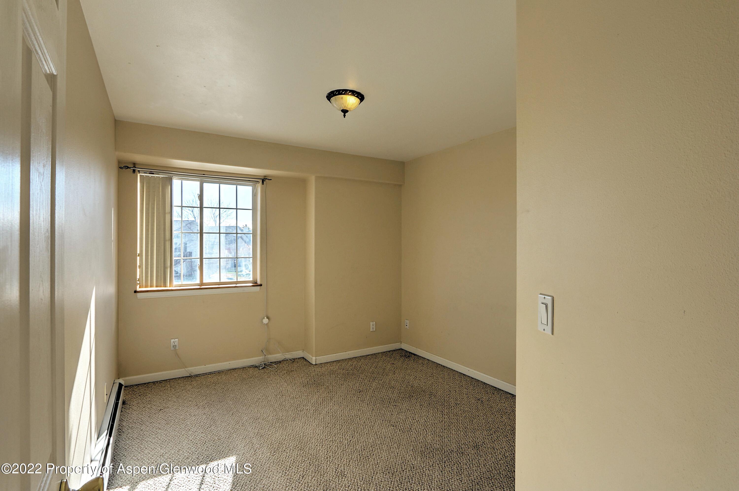 1220 Sage Court Rifle, CO 81650 - Photo 27 of 41 a view of an empty room with a window