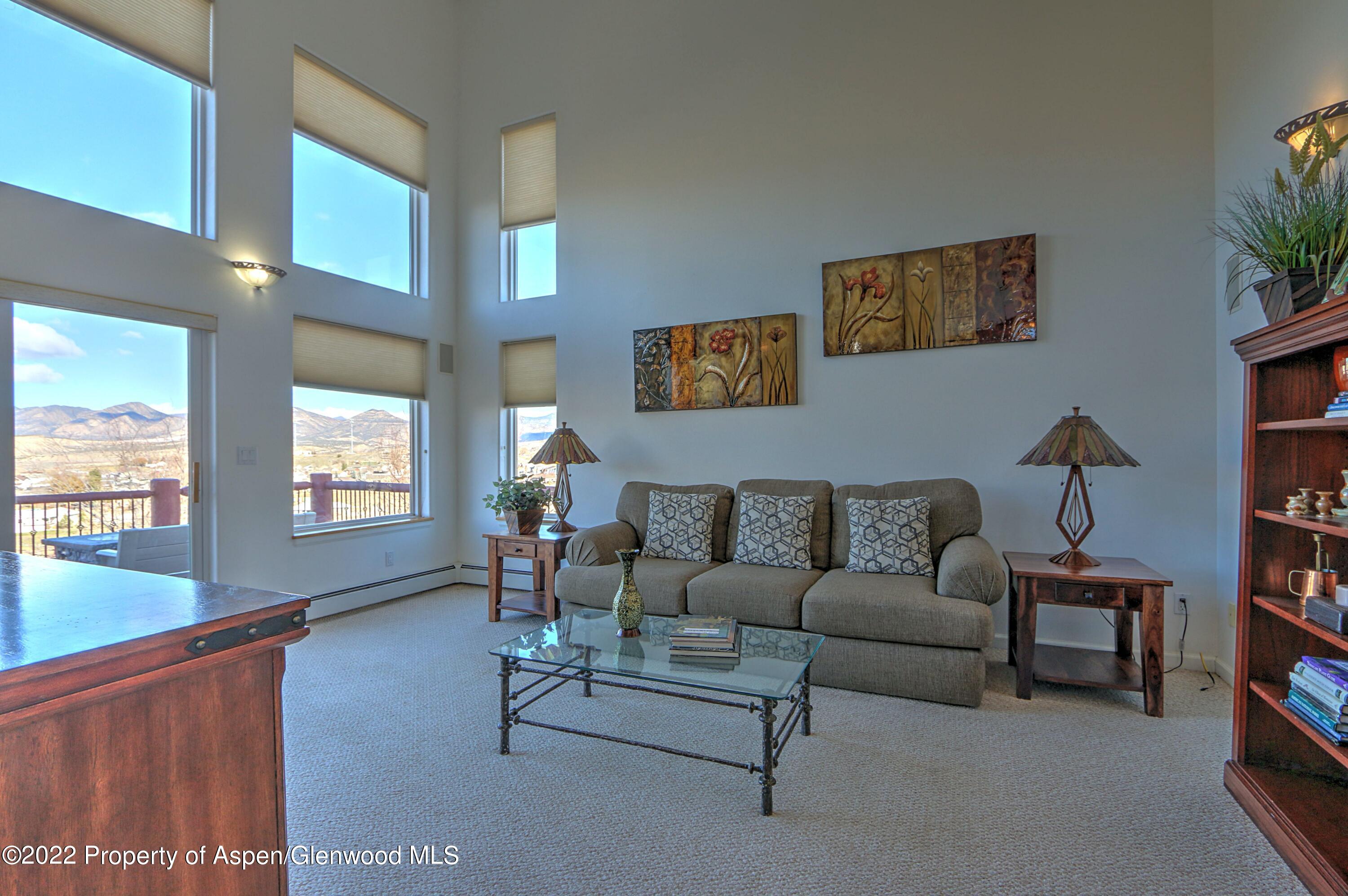 1220 Sage Court Rifle, CO 81650 - Photo 31 of 41 a living room with furniture wall paintings and a window
