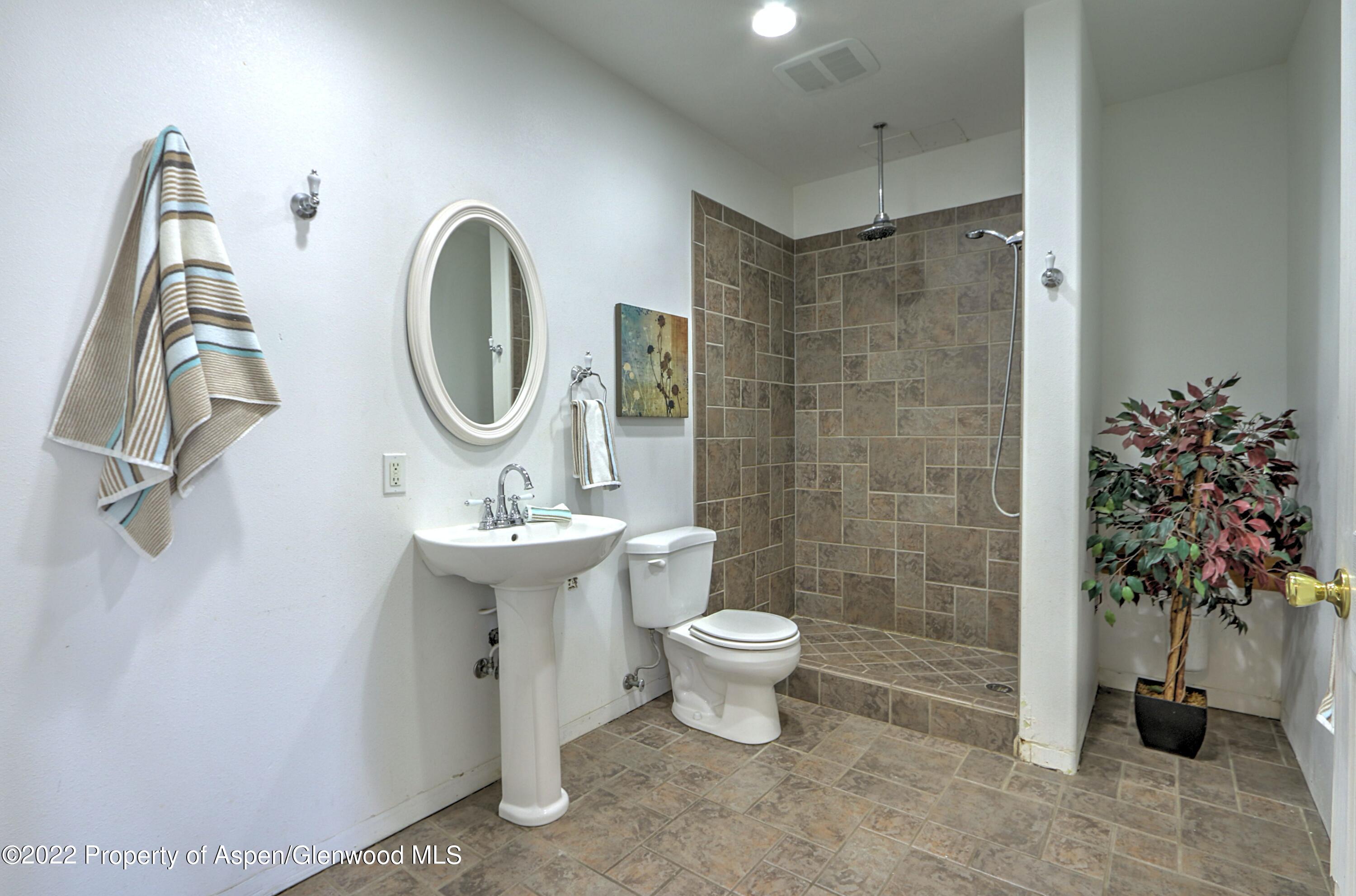 1220 Sage Court Rifle, CO 81650 - Photo 35 of 41 a bathroom with a toilet sink and shower