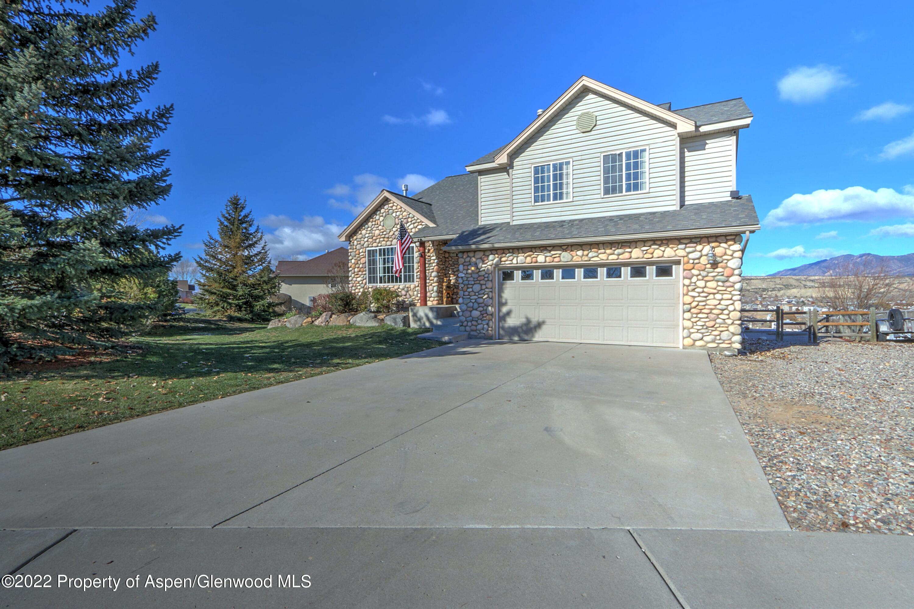 1220 Sage Court Rifle, CO 81650 - Photo 40 of 41 a front view of a house with a yard