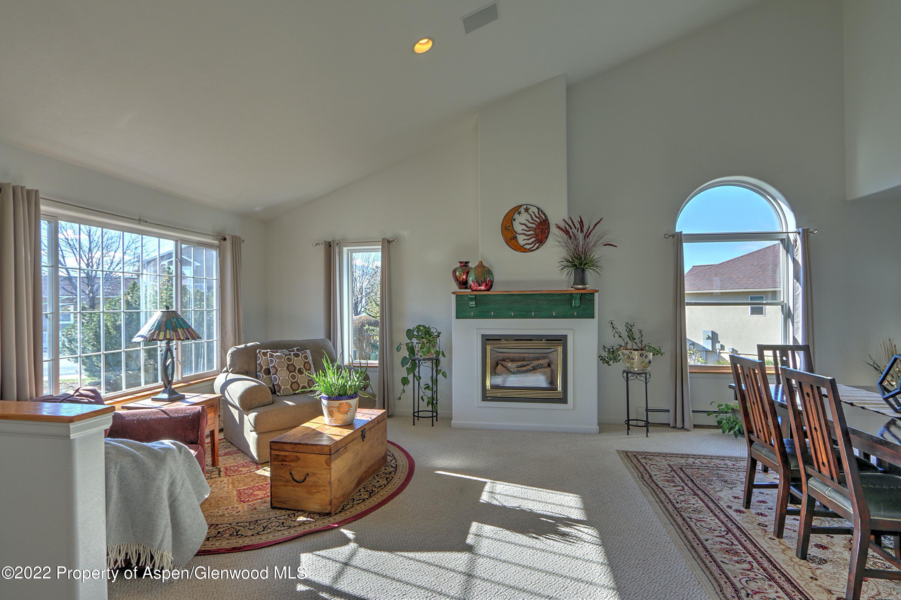 1220 Sage Court Rifle, CO 81650 - Photo 10 of 41 a living room with furniture fireplace and a large window