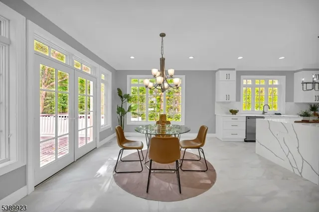 a dining room with furniture a chandelier and wooden floor