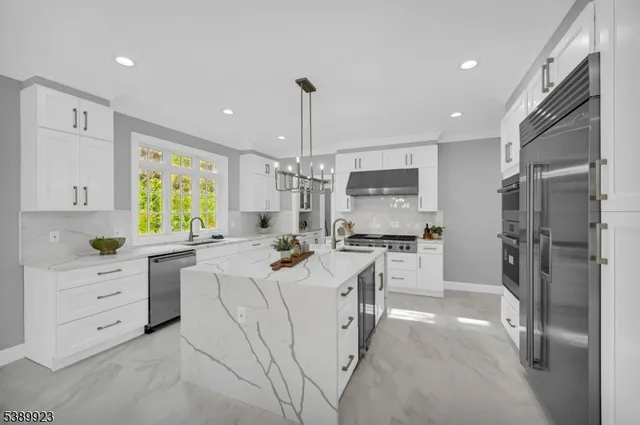 a kitchen with a refrigerator and a stove top oven