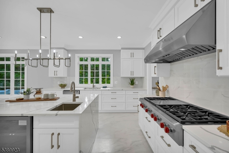 466 White Oak Ridge Road Short Hills, NJ 07078 - Photo 19 of 49 a kitchen with stainless steel appliances a sink a stove and a wooden floors