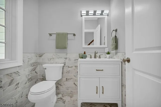 a bathroom with a sink toilet and mirror
