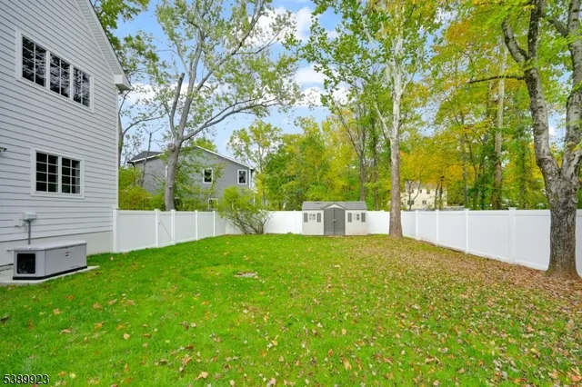 a view of white house with backyard and garden