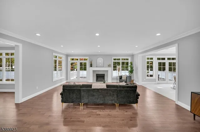 a living room with fireplace furniture and a large window