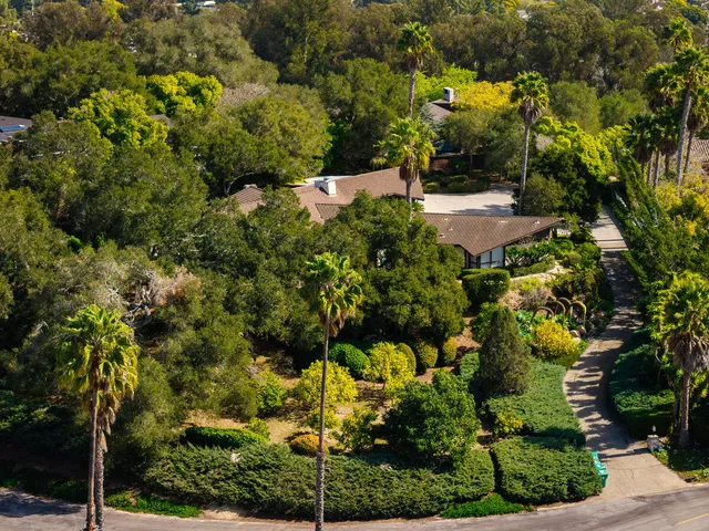 an aerial view of a house with yard and street view
