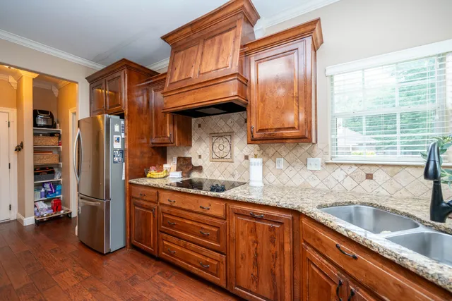 a kitchen with stainless steel appliances granite countertop a sink and cabinets