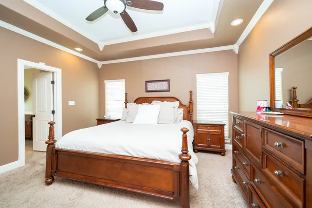 a bedroom with a bed and a chandelier