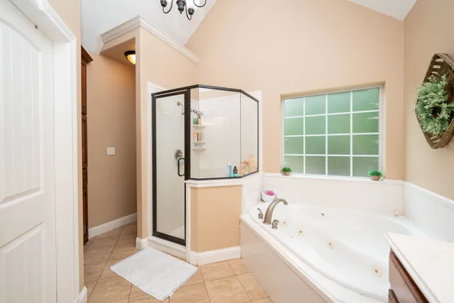 a bathroom with a bathtub and a shower