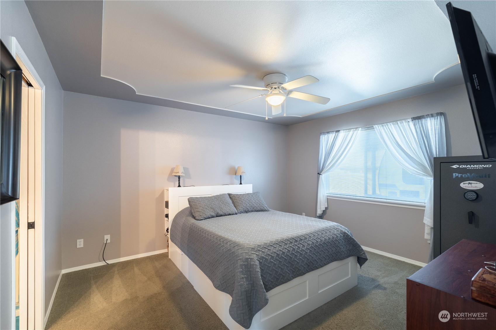 18940 Melon Street Southwest Rochester, WA 98579 - Photo 12 of 39 a bedroom with a bed and a chandelier