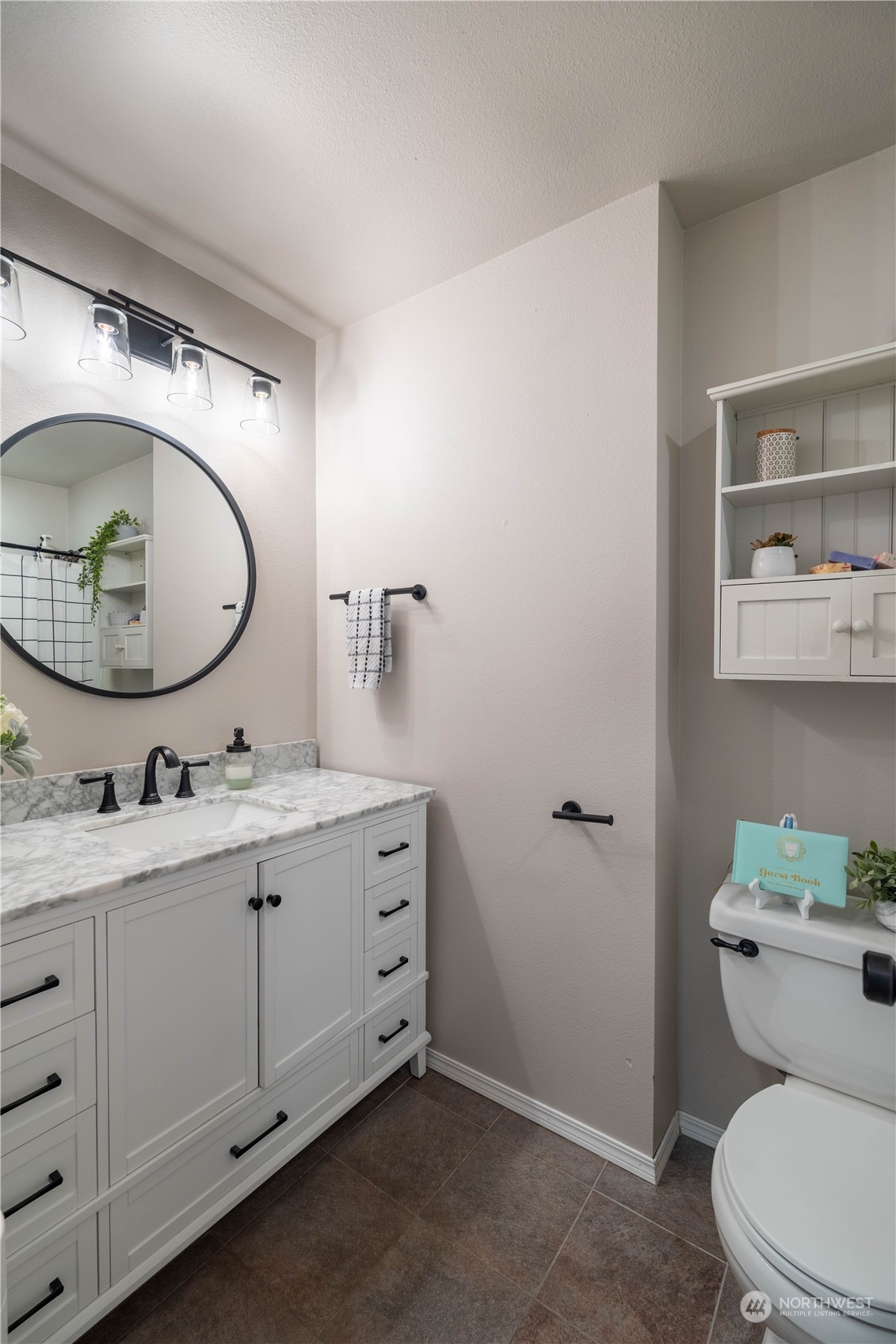 18940 Melon Street Southwest Rochester, WA 98579 - Photo 18 of 39 a bathroom with a toilet a sink and mirror