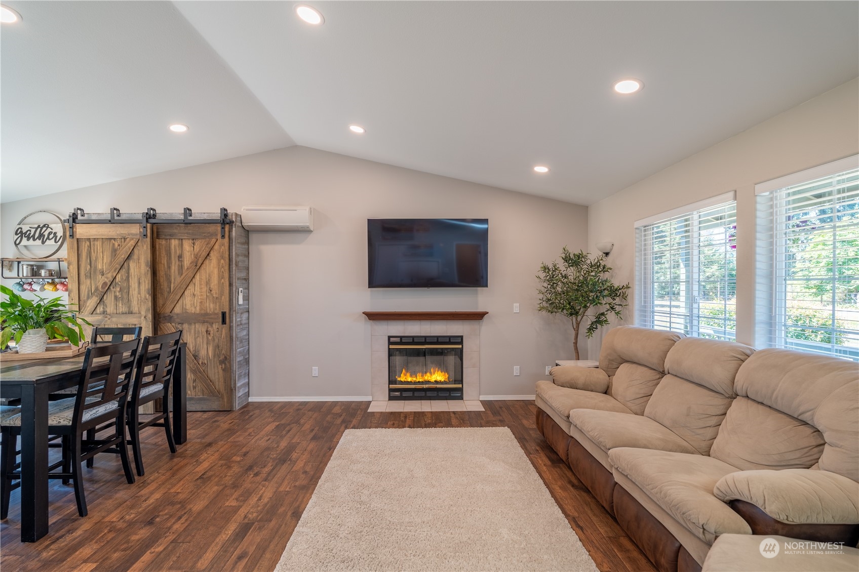 18940 Melon Street Southwest Rochester, WA 98579 - Photo 6 of 39 a living room with furniture flat screen tv and a fireplace