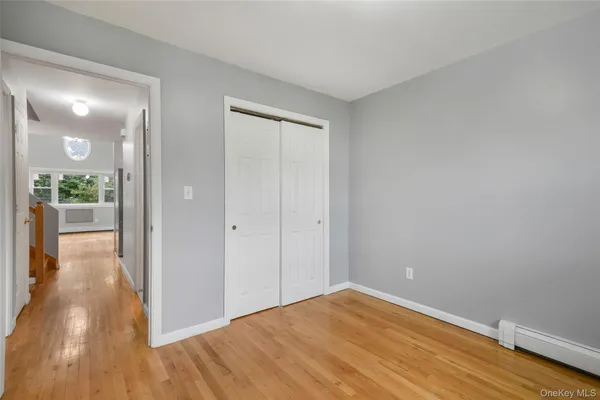 a view of a room with wooden floor