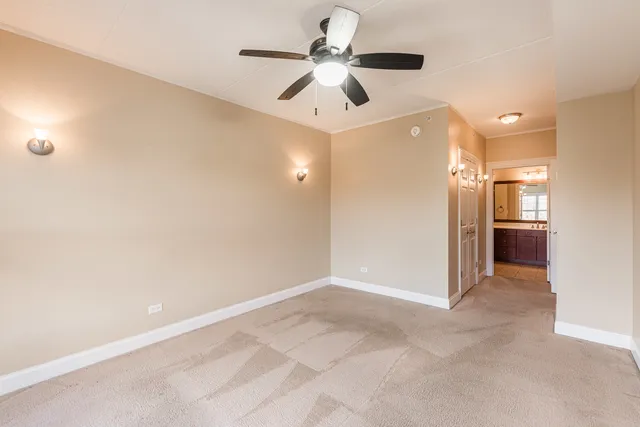 an empty room with fan and a ceiling fan