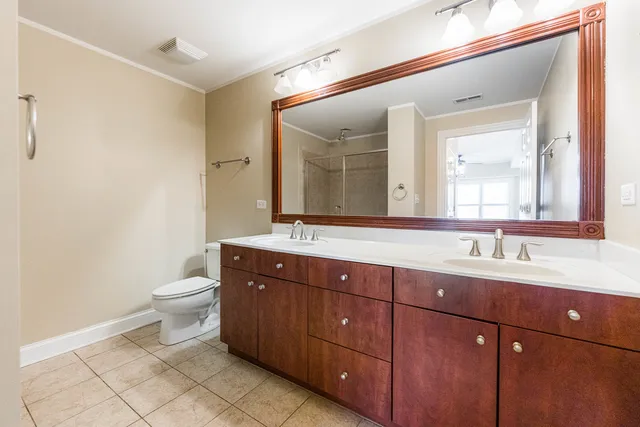 a bathroom with a double vanity sink and a mirror