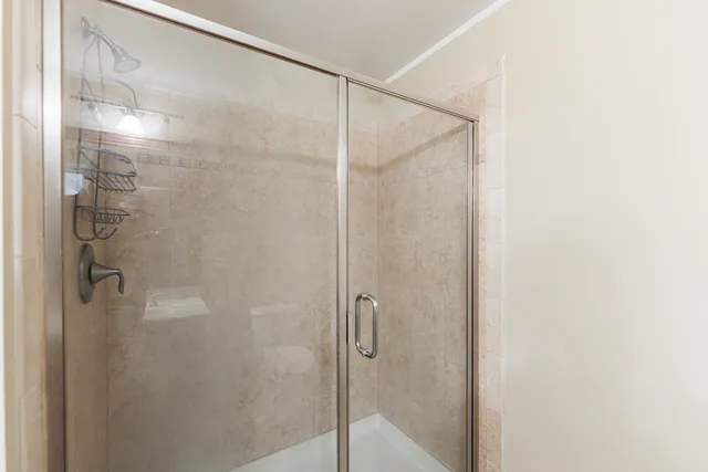 a bathroom with a glass shower door