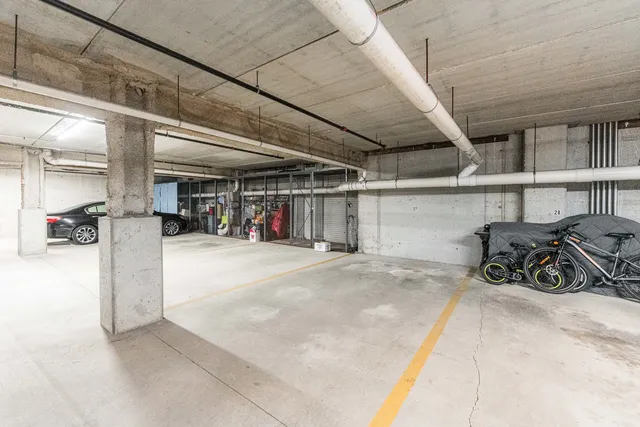 a view of parking garage with cars