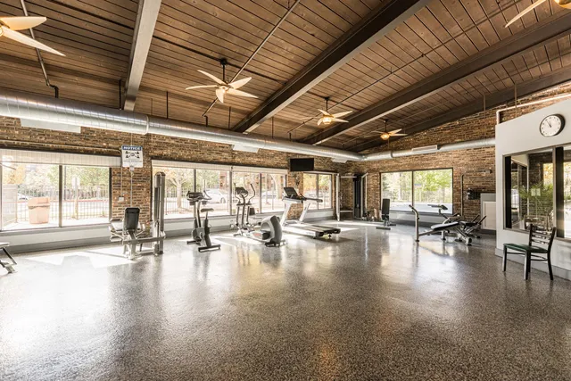 a view of a gym with pool table and chairs