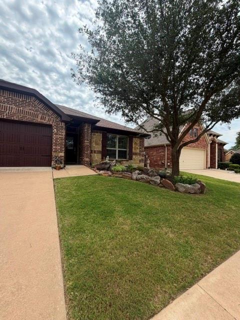 202 Tower Circle Terrell, TX 75160 - Photo 5 of 39 a front view of a house with a garden and trees