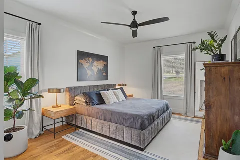 a spacious bedroom with a bed and a potted plant
