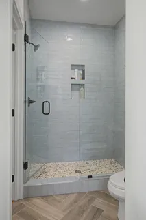 a bathroom with a shower toilet and a sink