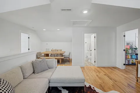 a living room with a couch and a book shelf