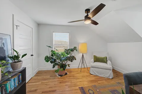 a view of living room with furniture and a potted plant