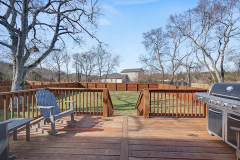 a view of a deck with chairs and wooden floor