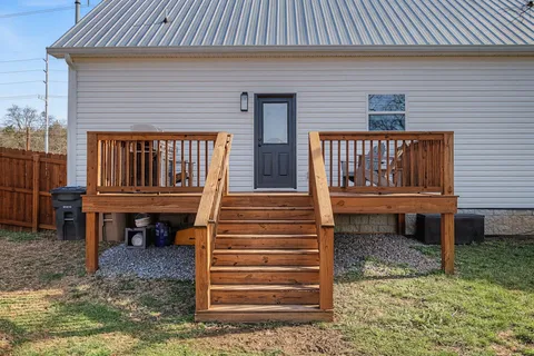 a front view of a house with a wooden deck