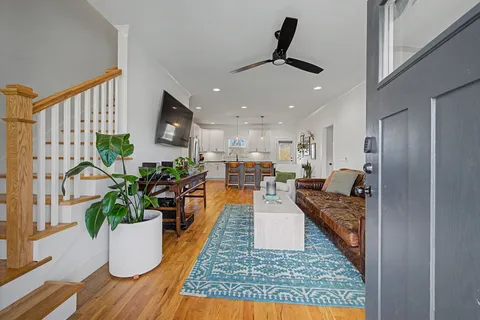 a living room with furniture and a potted plant