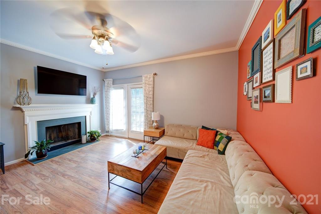 1014 Queens Road Charlotte, NC 28207 - Photo 11 of 18 a living room with furniture a flat screen tv and a fireplace