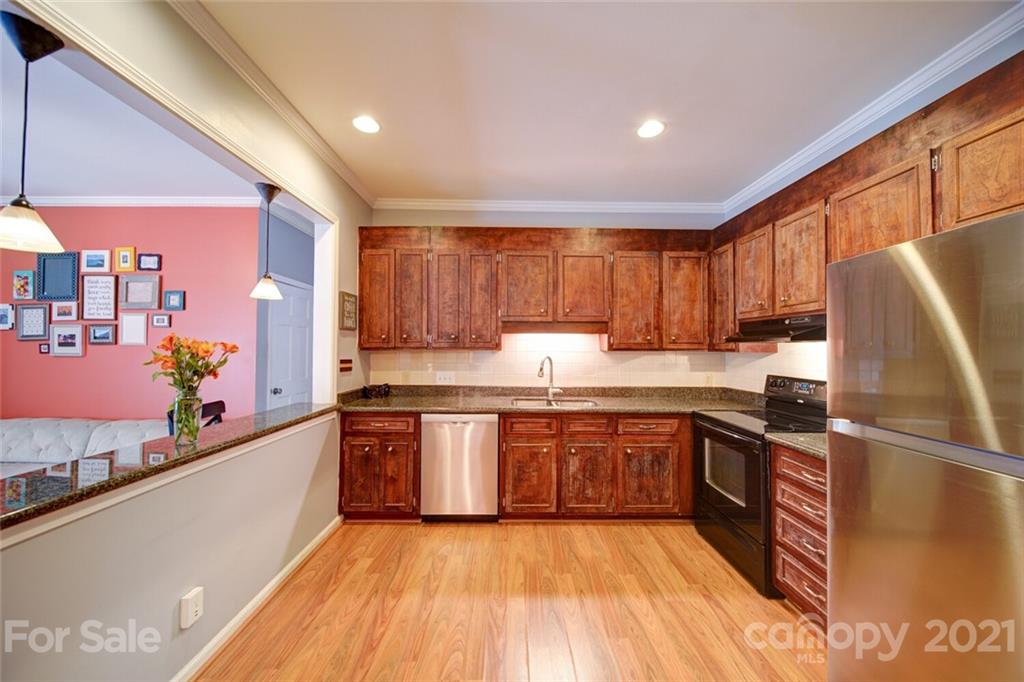 1014 Queens Road Charlotte, NC 28207 - Photo 13 of 18 a large kitchen with stainless steel appliances granite countertop a sink and cabinets