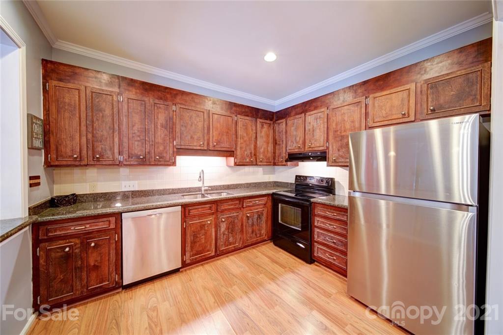 1014 Queens Road Charlotte, NC 28207 - Photo 14 of 18 a kitchen with stainless steel appliances granite countertop a refrigerator sink and cabinets