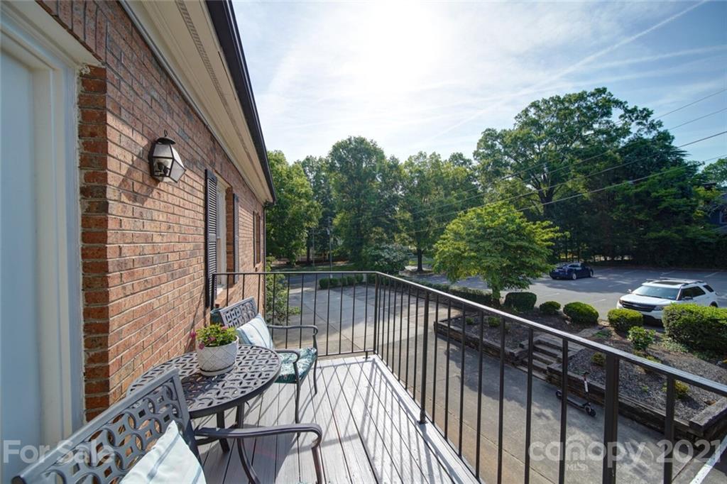 1014 Queens Road Charlotte, NC 28207 - Photo 17 of 18 a balcony with wooden floor and outdoor seating