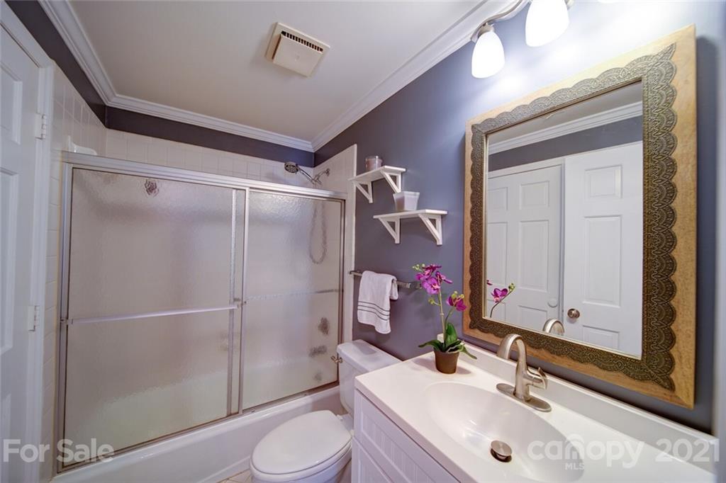 1014 Queens Road Charlotte, NC 28207 - Photo 6 of 18 a bathroom with a sink vanity granite toilet and shower
