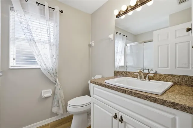 a bathroom with a glass shower door