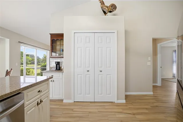 a view of a patio with a table chairs and a floor to ceiling window
