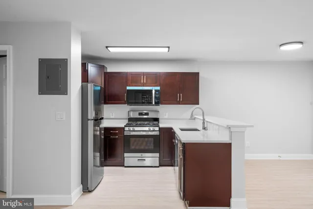 a kitchen with stainless steel appliances granite countertop a stove top oven a sink and dishwasher