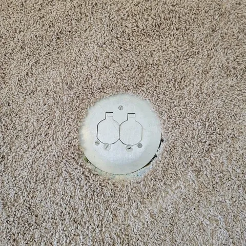 an empty room with windows and chandelier fan