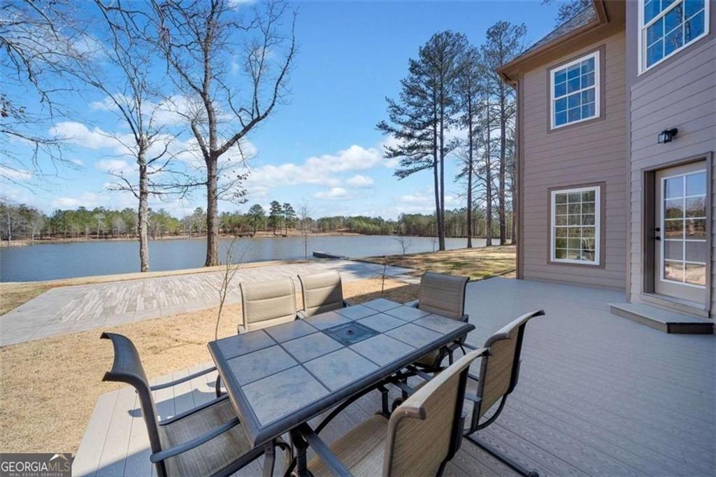1401 Rainey Road Temple, GA 30179 - Photo 13 of 58 a view of a patio with wooden floor table and chairs