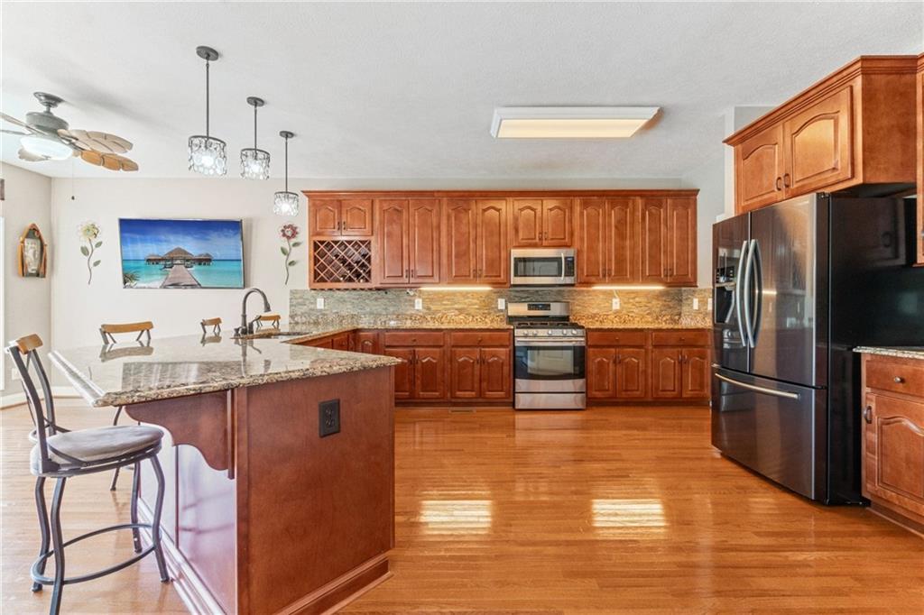 1401 Rainey Road Temple, GA 30179 - Photo 41 of 58 a kitchen with stainless steel appliances a stove a sink a refrigerator cabinets and dining table