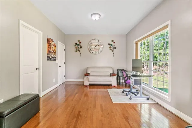 a view of an empty room with wooden floor
