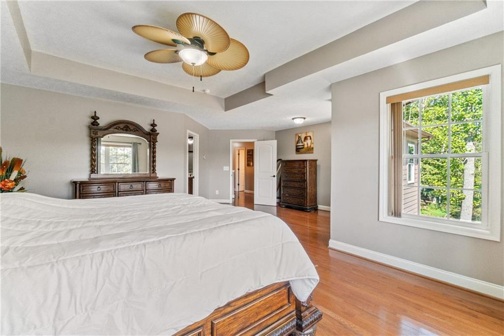 1401 Rainey Road Temple, GA 30179 - Photo 48 of 58 a bedroom with a bed and wooden floor