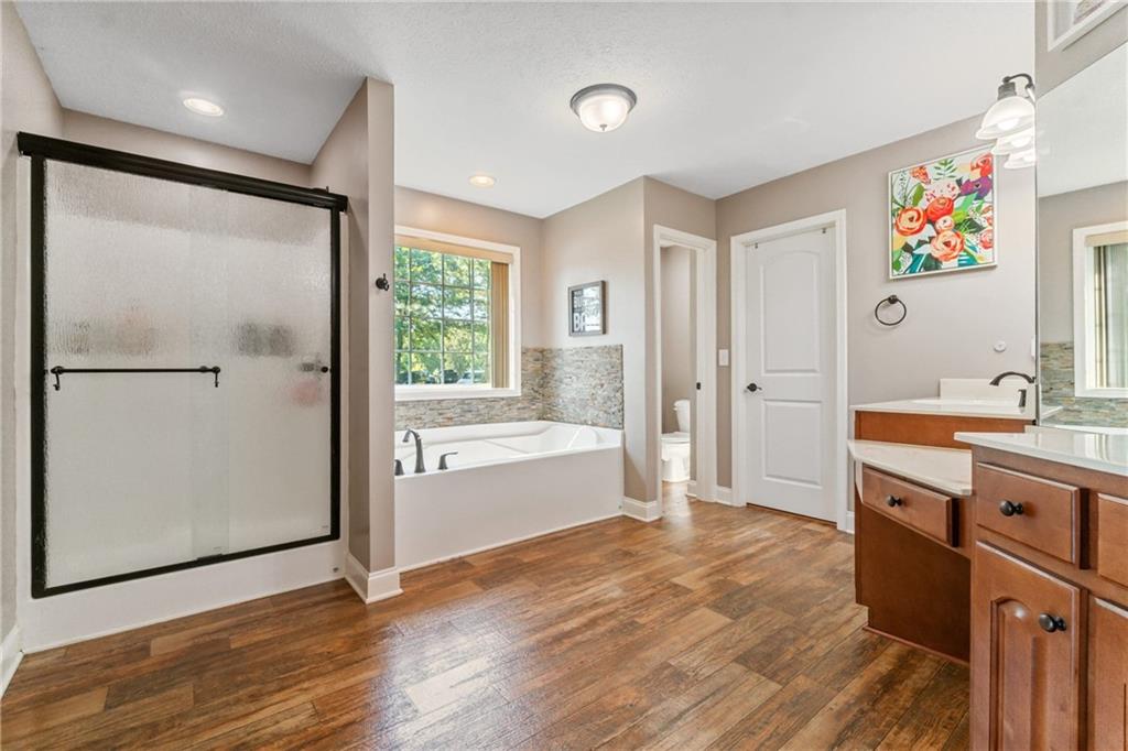 1401 Rainey Road Temple, GA 30179 - Photo 49 of 58 a spacious bathroom with a granite countertop tub sink shower and mirror