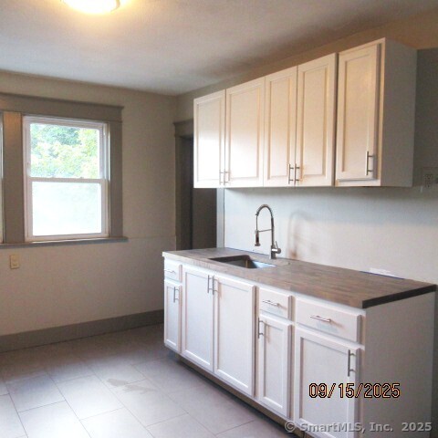 67 Burlington Avenue, Unit 69 Bristol, CT 06010 - Photo 12 of 15 a kitchen with stainless steel appliances granite countertop a sink and cabinets with wooden floor
